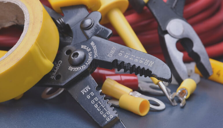 Electrical services NB - a collection of electrical tools with yellow handles and red wiring