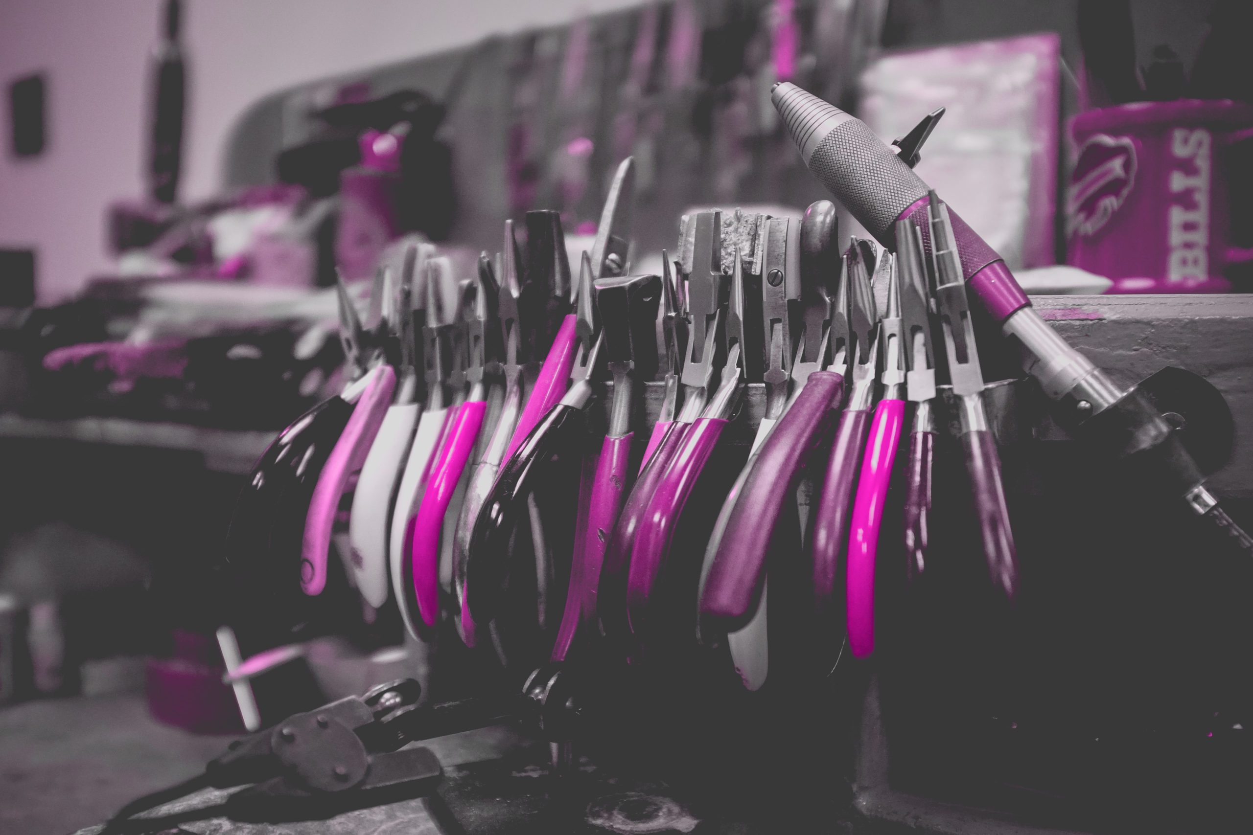 Pink filtered image of a lone line of pliers - small residential electrician